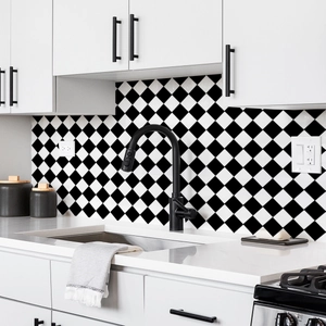 Macro detail of black and white diamond pattern tile stickers on a modern kitchen backsplash