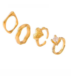 Set of four 18k gold plated stainless steel rings featuring zircon inlays and geometric shapes