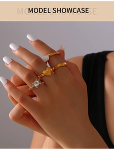 Close-up of geometric 18k gold plated ring set with zircon inlay and heart relief