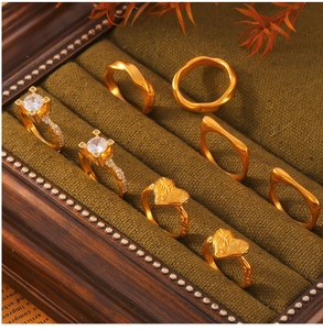 Detail of vintage 18k gold plated geometric zircon rings set in a green velvet box
