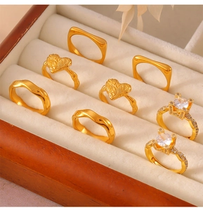 Close-up of gold geometric rings with zircon settings in a velvet jewelry box organizer