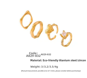 Detailed set of four 18k gold plated titanium rings with zircon inlay and heart design