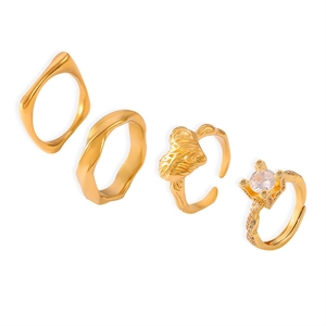 Set of four 18k gold plated geometric rings including zircon inlay and wavy textures