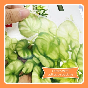 Detail of self-adhesive green plant wall sticker with silver-green leaf patterns