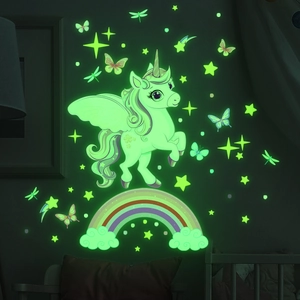Glow-in-the-dark wall stickers featuring rainbow unicorn, stars, and butterflies in dark room