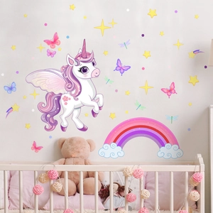 Detailed view of luminous unicorn and rainbow wall decals in a cozy nursery room setting