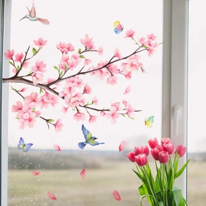 Detail of pink cherry blossom wall stickers with birds and butterflies on window