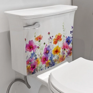 Detailed view of colorful floral stickers applied to a white ceramic toilet tank surface