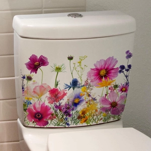 Close-up of colorful floral toilet tank decals featuring wildflowers on white ceramic