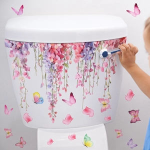 Pink cherry blossom and butterfly stickers on white toilet tank with wisteria flowers
