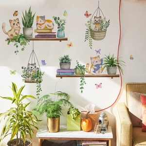 Macro detail of watercolor cat and potted plant wall decals in a cozy home setting