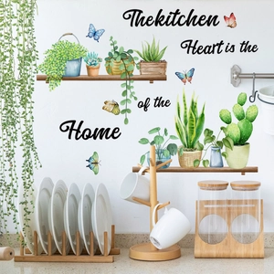 Vinilos decorativos de plantas en acuarela y frase de cocina sobre pared blanca