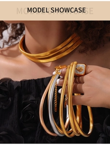 Detail of 18K gold plated triple layered snake chain necklace and lion head ring set