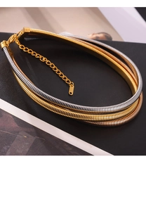 Close-up of triple-layered snake chain necklace in gold and silver finish with lobster clasp