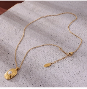 Détail du collier en acier inoxydable doré 18k avec pendentif perle et fermoir homard
