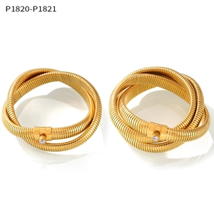 Close-up of 18K gold plated multi-wrap Tubogas bracelets with zircon accents