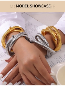 Macro shot of gold and silver snake bone spiral bangles featuring sparkling zircons