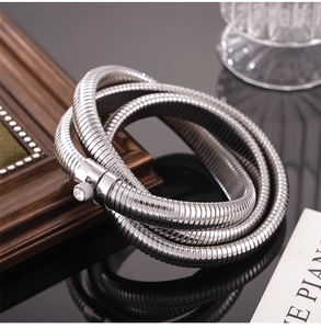 Macro detail of silver snake chain bracelet with sparkling zircon-inlaid screw closure