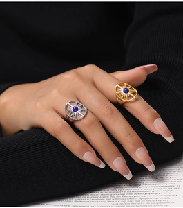Close-up of vintage eight-point star rings with blue natural stone on gold and silver bands