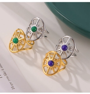 Detail of vintage sunburst rings with malachite and lapis lazuli on textured surface