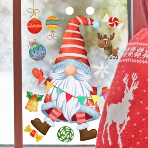 Detailed view of Christmas gnome and snowflake static window clings on glass surface