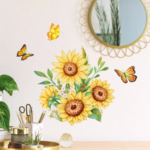 Stickers muraux tournesols et papillons sur un mur blanc à côté d'un miroir doré
