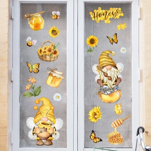 Détail de stickers gnomes abeilles et tournesols sur une porte vitrée blanche