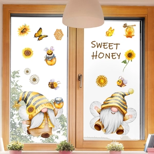 Detail of bee and gnome window stickers showing double-sided watercolor garden motifs