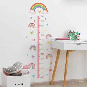 Rainbow and butterfly growth chart wall sticker in a cozy nursery setting with white desk