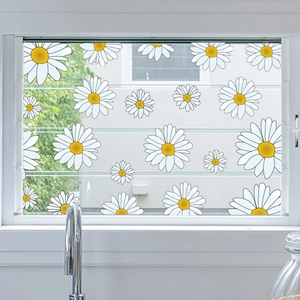 Detail of white and yellow daisy window stickers on glass for home kitchen decoration