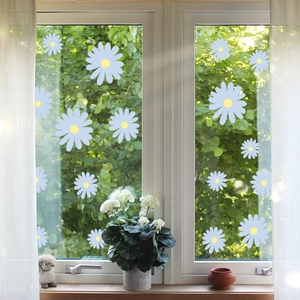 Detail of light blue daisy window stickers with yellow centers on transparent glass