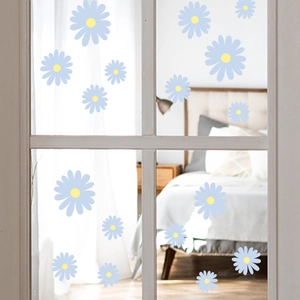 Fresh daisy floral window stickers in blue and yellow on glass panes for home decor