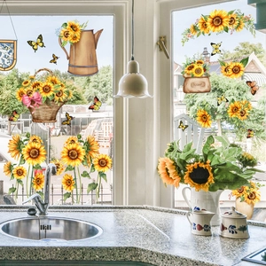 Detail of sunflower and butterfly window stickers on a kitchen glass surface
