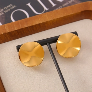 Elegant 18k gold plated wave-textured disc earrings on a minimalist black display stand