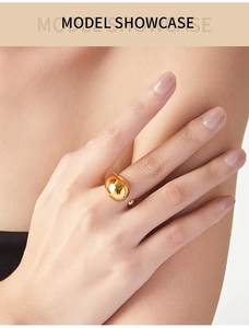 Close-up of a minimalist 18K gold plated teardrop open ring worn on a finger