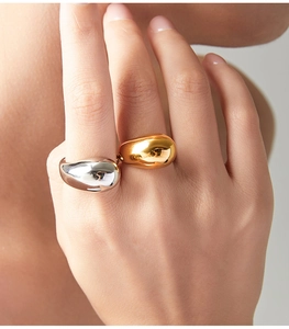 Detailed view of minimalist gold and silver thick irregular teardrop rings on model