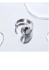 Macro shot of silver teardrop ring with mirror-polished finish and open adjustable band