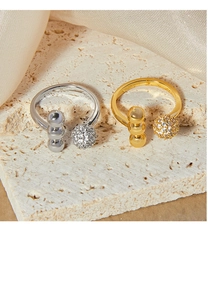 Detailed view of gold and silver ball rings with cubic zirconia spheres and beads