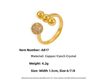 Detail view of gold open ring with cz ball and beads including product size specifications