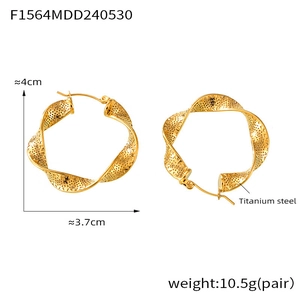 Detailed view of gold titanium steel U-shaped twisted hoop earrings with hollow texture