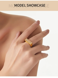 Macro view of gold plated ring featuring a rectangle top with pearls and zircons