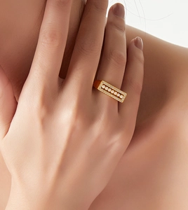 Close-up of gold geometric ring featuring six pearls and micro-pave crystals