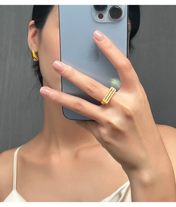 Close-up of a gold rectangle ring with six pearls and zircon accents worn on the hand