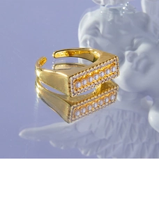 Macro view of gold plated adjustable ring with rectangle pearl setting and zirconia inlay