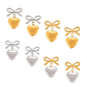 Boucles d'oreilles nœud et cœur en or 18K et argent, finition polie sur fond blanc pur