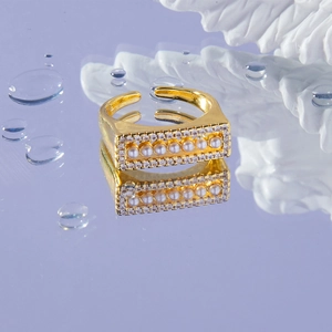 Luxury gold adjustable open ring featuring central pearls and sparkling pavé crystals