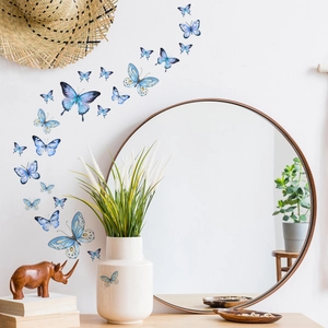 Luminous blue butterfly wall decals for living room decor with artistic flying patterns