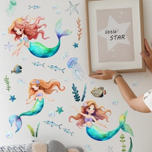 Detail of glow-in-the-dark mermaid and sea creature wall stickers in a child room setting