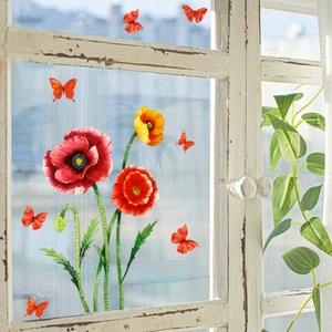 Detail view of red poppy and butterfly window decals on a clear glass pane