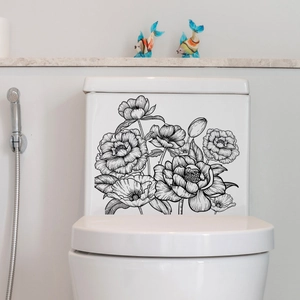 Detailed view of floral line art wall decals applied on a white ceramic toilet tank surface